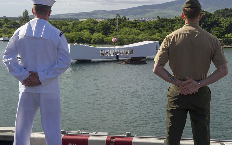 Sailors and Marines man the rails aboard Wasp-class amphibious assault ship USS Essex while passing the USS Arizona Memorial Dec. 6, 2015. 