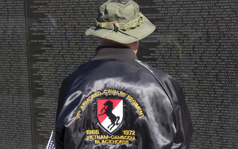 A Vietnam veteran pays his respects to fallen comrades at the Vietnam Veterans Memorial in Washington, D.C.