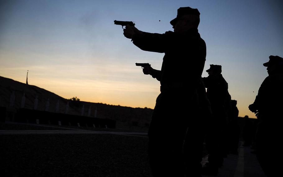 U.S. Marines stationed at Marine Corps Air Station Yuma, Ariz., engage in firearms training and qualification at the station pistol range, Wednesday, Jan. 20, 2016. 