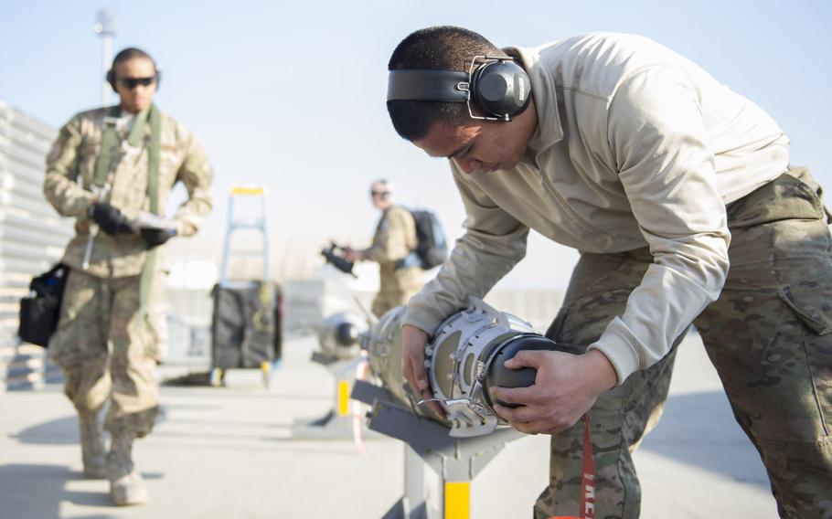 Airman 1st Class Rhaymark Neri, 455th Expeditionary Aircraft Maintenance Squadron weapons load crew member, secures a sensor cover on a GBU-54 munition after downloading it from an F-16 Fighting Falcon at Bagram Air Field, Afghanistan, on Friday, Jan. 15, 2016.