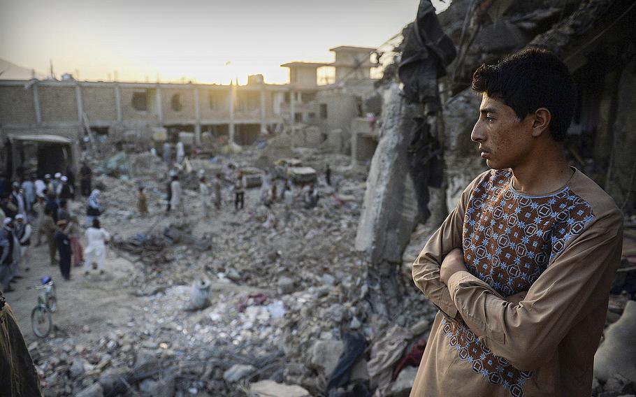 A boy looks across the devastation caused by a massive truck bomb in Kabul, Afghanistan, on Aug. 7, 2015. The bomb primarily struck civilians.