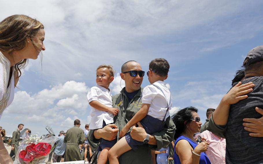 Lt. Cmdr. Pete Santos is greeted by sons Noah, left, and Jack along with his wife, Kristina Santos, after returning to Naval Air Station Oceana on Tuesday, July 13, 2021.