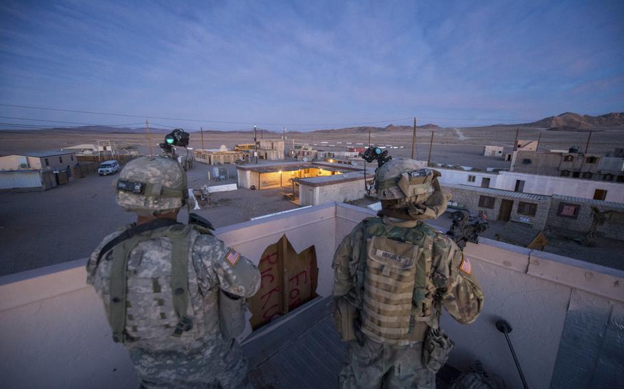 U.S. Army soldiers assigned to 3rd Cavalry Regiment, 1st Cavalry Division, pull security from an overwatch position during a village clearance operation at the National Training Center, Fort Irwin, Calif., Feb. 17, 2016.