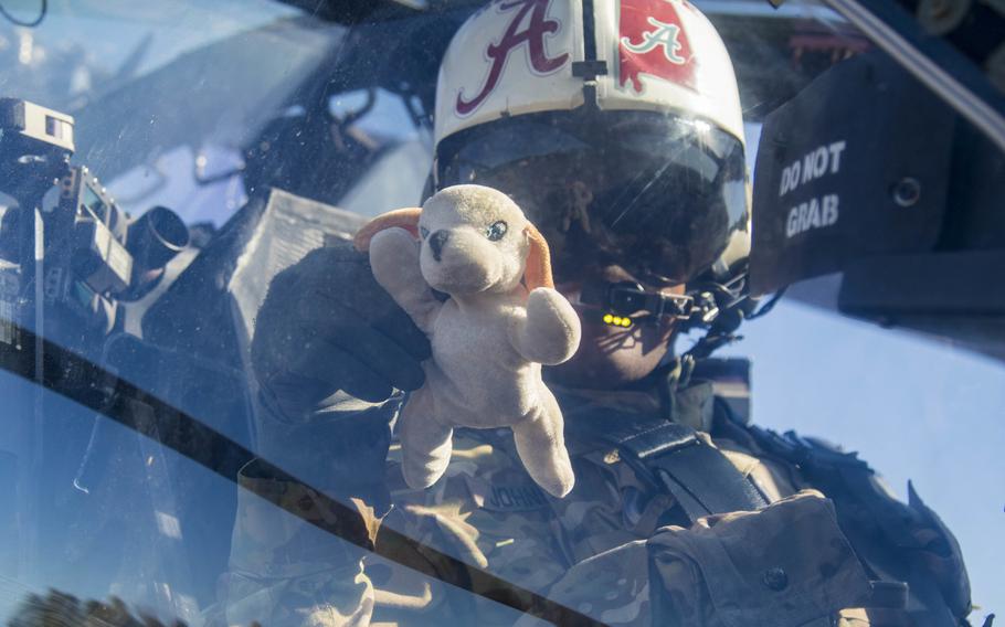 Cheif Warrant Officer 2 Harold Johnson, a pilot with 1st Attack Reconnaissance Battalion, 82nd Combat Aviation Brigade, holds up "Fluffy," a doll given to him by his daughter for good luck, at Fort A.P. Hill, Va., on Feb. 18, 2016. 