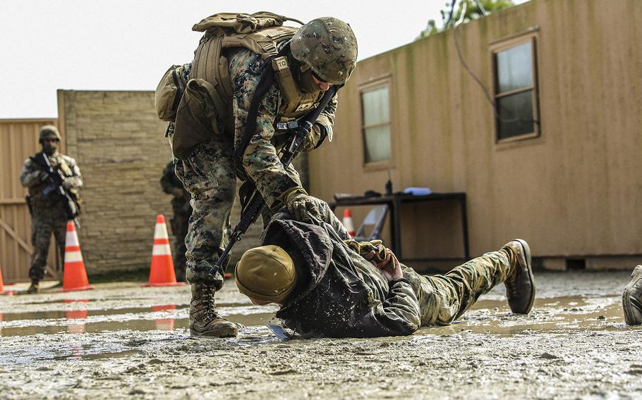 U.S. Marines with Bravo Company, 2nd Law Enforcement Battalion, subdue role players after a simulated altercation at a forward observation base during an interior guard training exercise at Forward Observation Base Hawk at Camp Lejeune, N.C., on Feb. 17, 2016. 