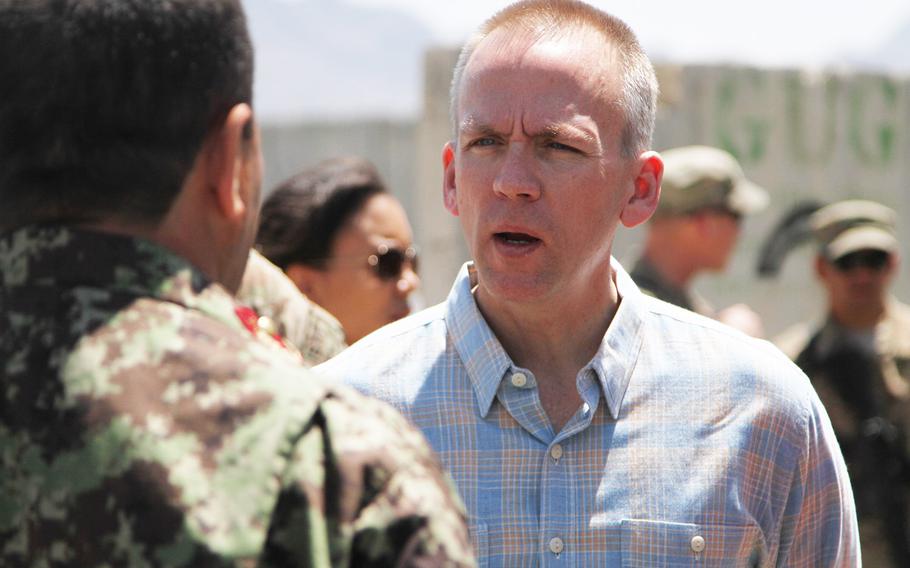 Brad Carson, then-Under Secretary of the Army, talks to an Afghan service member at Forward Operating Base Frontenac, April 18, 2014. 