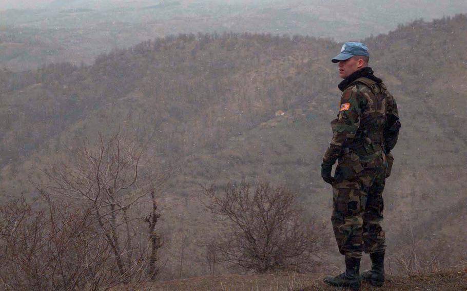 Spec. James Burke, 20, scans the hills of Serbia while patrolling the border of Macedonia in March, 1998.  Burke, based in Schweinfurt, Germany, is among 350 Americans on a U.N. mission to monitor borders in the Balkan country.  Although violence has erupted in the nearby Kosovo region, the Americans patrol a relatively quiet sector.