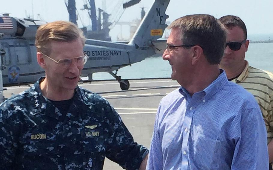 Secretary of Defense Ash Carter is greeted by 7th Fleet Commander Vice Adm. Joseph Aucoin on the USS Blue Ridge on April 11, 2016.