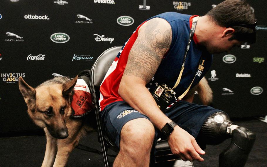 U.S. Air Force Staff Sgt. August O'Niell attends to his service dog Kai before talking to Stars and Stripes. O'Niell left leg was severely injured during a rescue mission in Afghanistan.