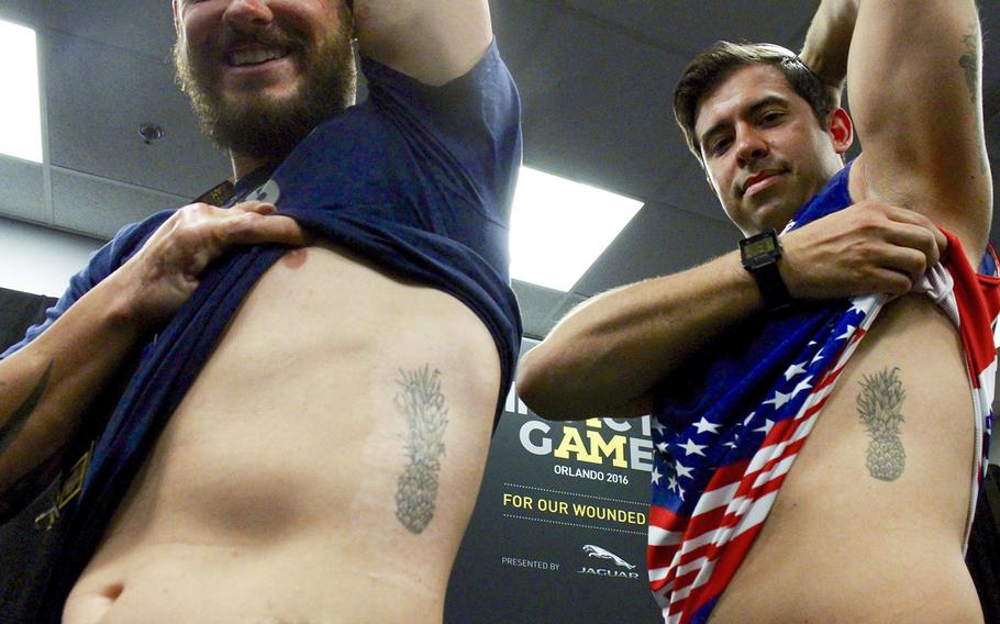 U.S. Air Force Tech Sgt. Leonard Anderson and Staff Sgt. August O'Niell show off their "Pineapple" tattoos. The two, along with five other wounded servicemen, formed the "Pineapple" group as a means for support.