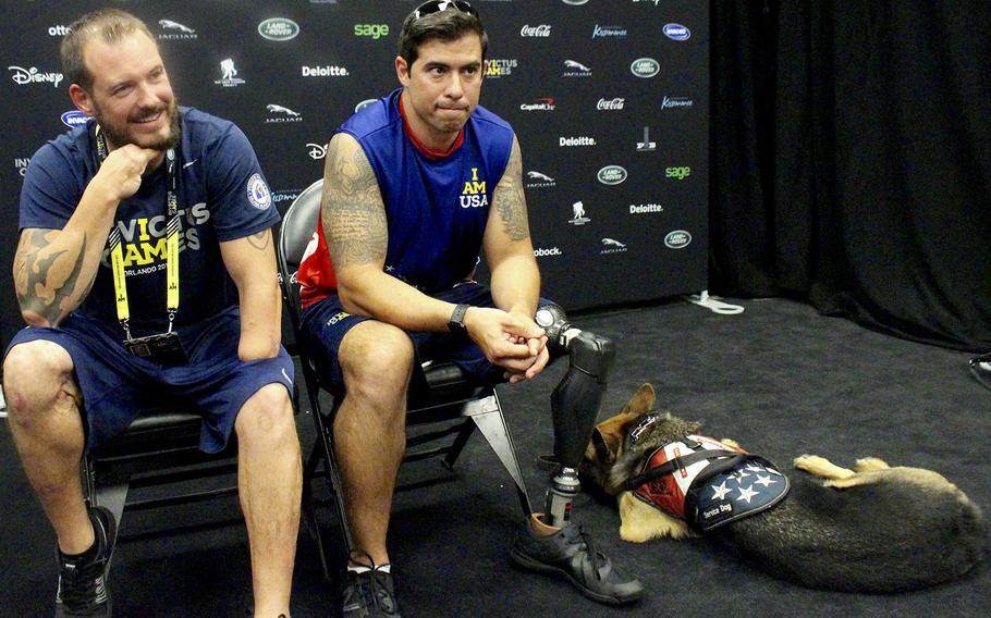 At the 2016 Invictus Game in Orlando, Fla., U.S. Air Force Tech Sgt. Leonard Anderson, left, and Staff Sgt. August O'Niell talk about the importance of helping each other. The two San Antonio residents, along with five other wounded servicemen, formed a group called "Pineapples" as a means for support.