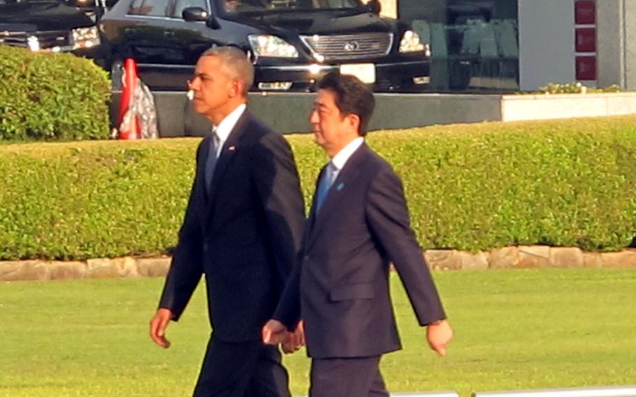 President Barack Obama and Japan Prime Minister Shinzo Abe arrive at Hiroshima Peace Memorial Park on May 27, 2016.Obama called on the world to pursue a long-term vision of a nuclear-free world Friday, as he became the first U.S. president ever to visit a Hiroshima memorial dedicated to those died in the world’s first wartime atomic bombing.
