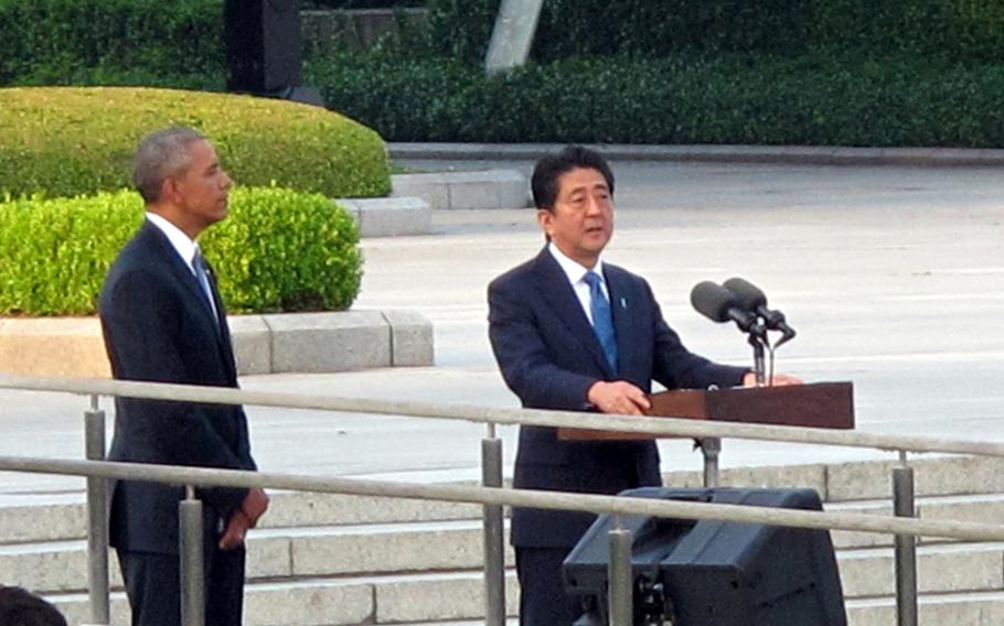 Japan Prime Minister Shinzo Abe speaks as President Barack Obama looks on at Hiroshima Peace Memorial Park on May 27, 2016. Obama called on the world to pursue a long-term vision of a nuclear-free world Friday, as he became the first U.S. president ever to visit a Hiroshima memorial dedicated to those died in the world’s first wartime atomic bombing.
