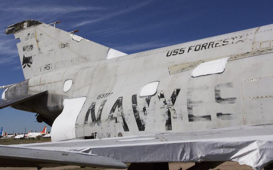 Markings on an F-4J fighter at the 309th Aerospace Maintenance and Regeneration Group facility near Tucson, Ariz., in October, 2015 tell part of its history, having been used by both the Navy and Marine Corps during a life that included time on the carrier USS Forrestal. The plane is owned by the National Naval Aviation Museum in Pensacola, Fla.