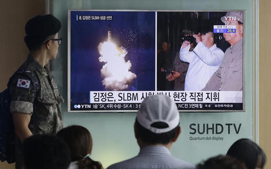 In this Thursday, Aug. 25, 2016, file photo, a South Korean army soldier watches a TV news program showing images published in North Korea's Rodong Sinmun newspaper of North Korea's ballistic missile believed to have been launched from underwater and North Korean leader Kim Jong-un, at Seoul Railway station in Seoul, South Korea. The UN Security Council is strongly condemning four North Korean ballistic missile launches in July and August, calling them "grave violations" of a ban on all ballistic missile activity. A press statement approved by all 15 members Friday night deplored the fact that the North's ballistic missile activities are contributing to its development of nuclear weapon delivery systems and increasing tensions.