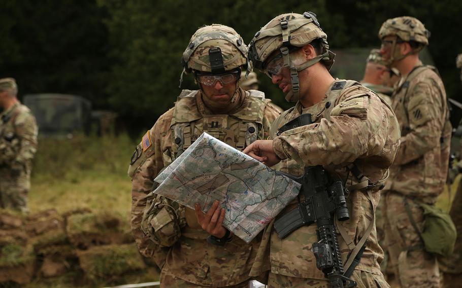 U.S. soldiers of the 3rd Infantry Division point at a map prior to conducting a 33rd Romanian Mountain Brigade Combined Arms Rehearsal during an exercise in Hohenfels Germany, Sept. 5, 2016.