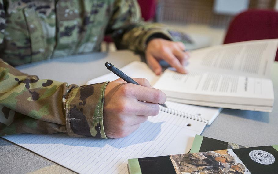 A military photo illustration depicts a servicemember studying.