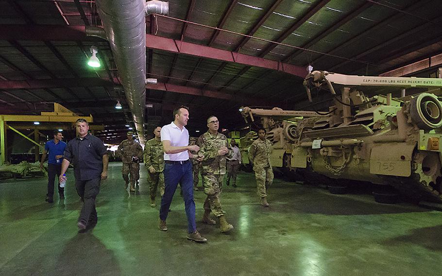 U.S. Army Secretary Eric Fanning speaks with soldiers during a warehouse tour September 19, part of the rolling stock of the 401st Army Field Support Brigade, at Camp Arifjan, Kuwait. 