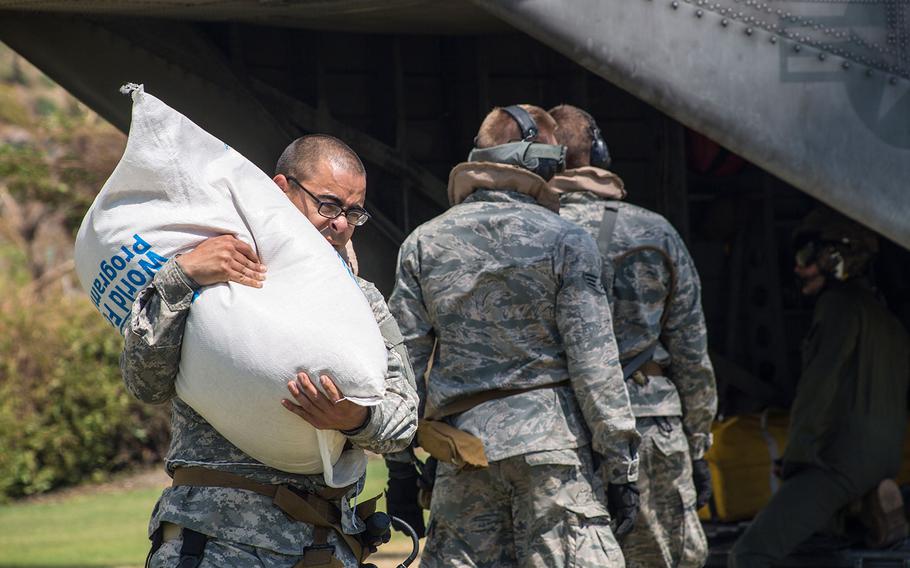 U.S. servicemembers with Joint Task Force Matthew deliver bags of rice at Les Anglais, Haiti on Oct. 13, 2016.