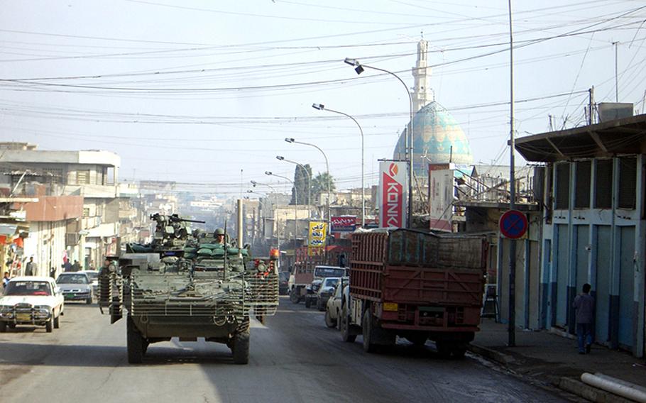 Strykers on Patrol in Mosul, Iraq, with the "Easter Egg" mosque in the background in Jan. 2006.