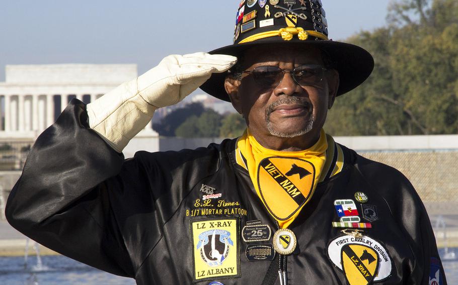 Vietnam War veteran Ed Times salutes during a Veterans Day ceremony at the National World War II Memorial in 2014.