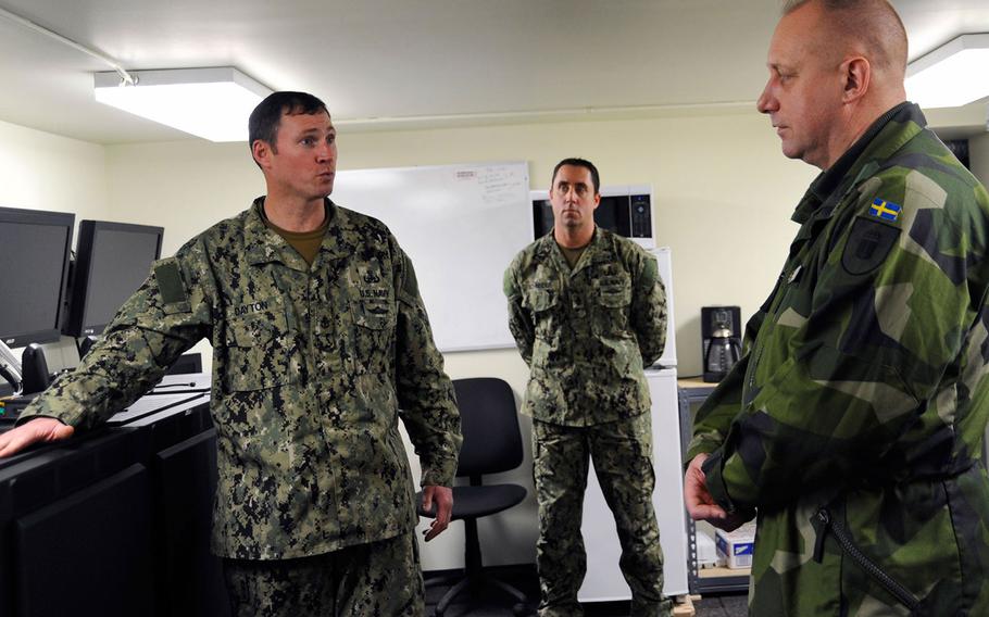 Explosive ordnance disposal technician Scott Dayton (left) speaks with Rear Adm. Jan Thornqvist (right), chief of staff of the royal Swedish navy, during his visit to Joint Expeditionary Base Little Creek-Fort Story on March 6, 2013 in Virginia Beach, Va.