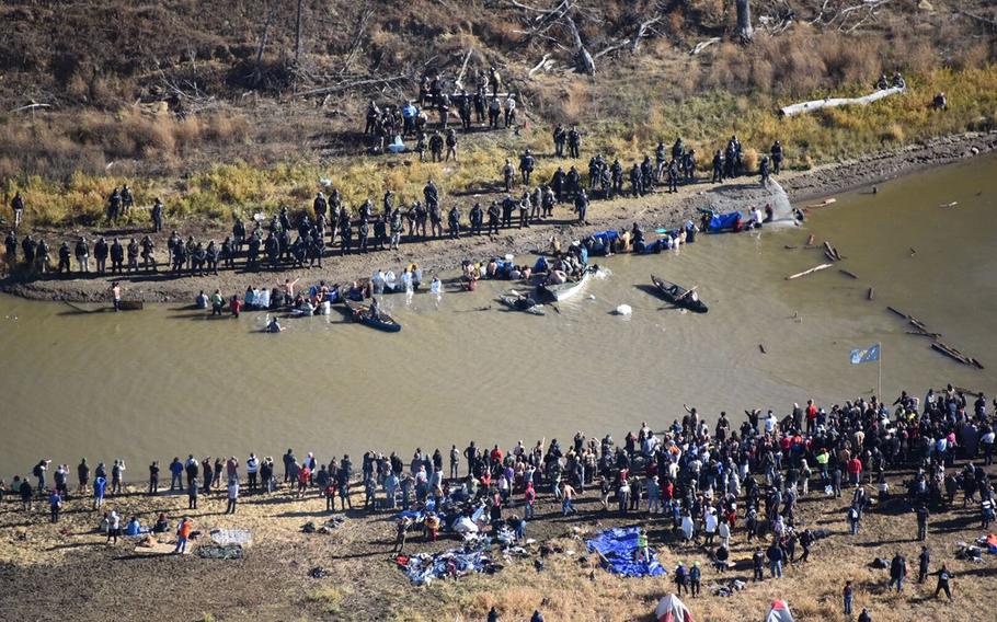 Police use pepper spray and tear gas to push demonstrators back as they try to cross a creek on Wednesday, Nov. 2, 2016, to prevent construction of the Dakota Access Pipeline.