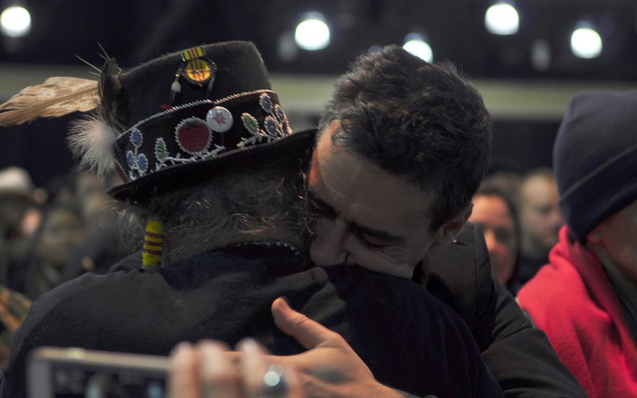 Wes Clark Jr., an organizer of Veterans for Standing Rock, hugs a member of the Standing Rock Sioux tribe during a gathering of veterans and tribal elders Monday, Dec. 5, 2016.