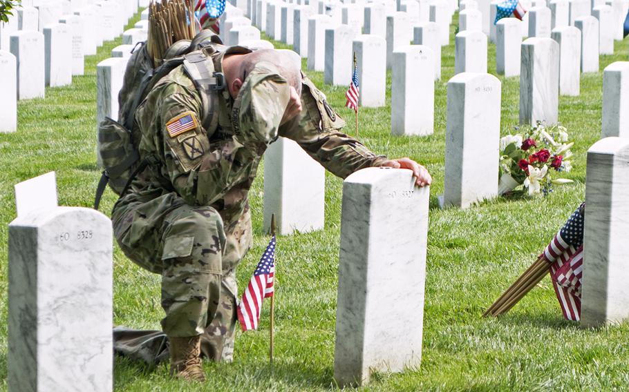Lt. Col. Ryan Morgan pauses at the grave of U.S. Army Capt. Ian Patrick Weikel at Arlington National Cemetery, May 26, 2016.