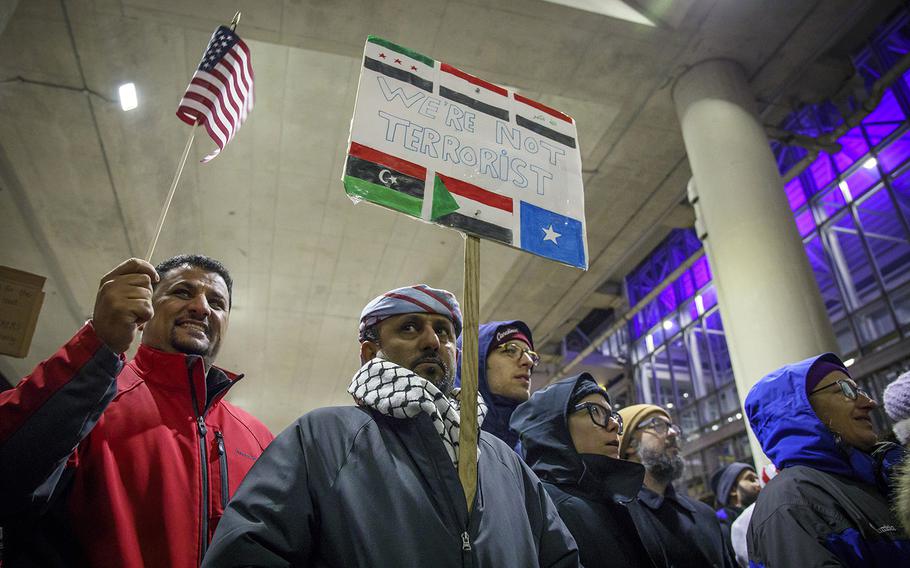 Amin Al-Barati, left, and Khaled Ahemd join other demonstrators in reaction to the executive order travel ban on Sunday, Jan. 29, 2017 outside Terminal 5 of O'Hare International Airport. 