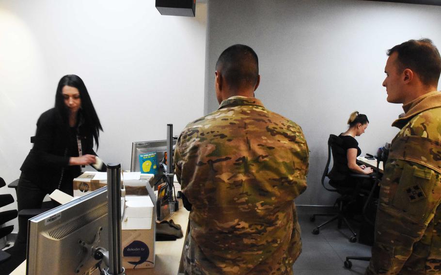 A group of American soldiers set up cellphone service at a shop in Zagan, Poland. The recent influx of Americans in Zagan has been a boon for the local cell phone stores. 

