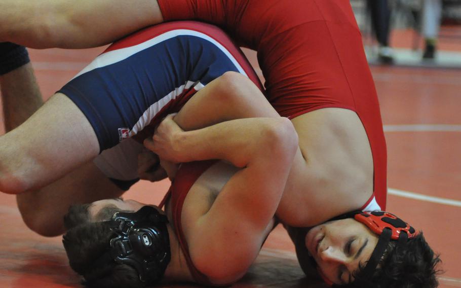 American Overseas School of Rome's Matthew McClure maneuvers Aviano's Andrew North in a 152-pound match at the Southern sectional on Saturday, Feb. 11, 2017. McClure won and advanced to the European championships.