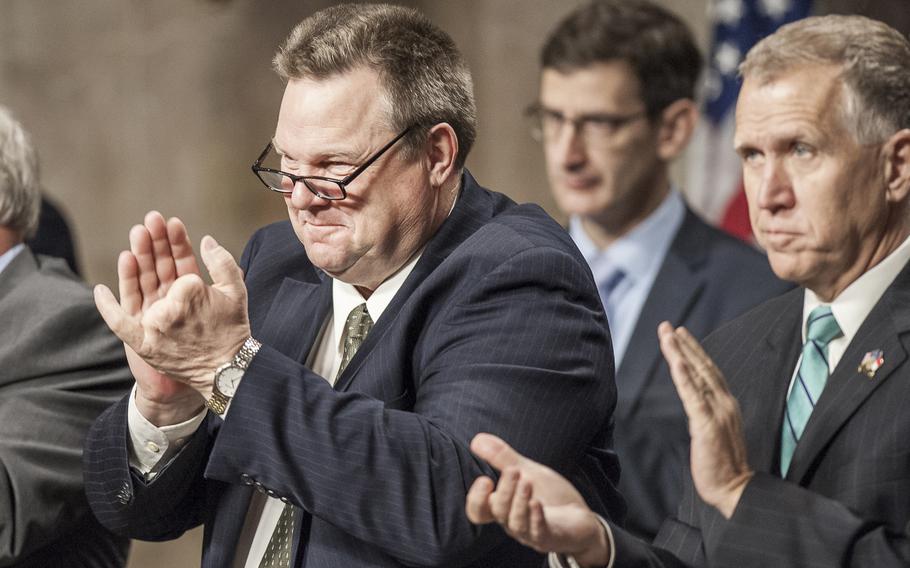 Sen. Jon Tester, D-Mont., and Sen. Thom Tillis, R-N.C., clap during a presentation on Capitol Hill on Wednesday, March 1, 2017, as representatives from the American Legion addressed members of Congress on issues of concern to military veterans.