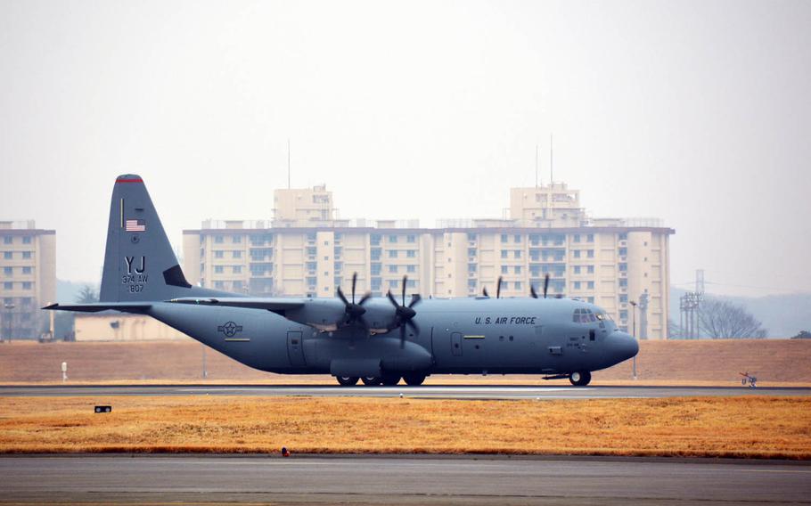 The first of 14 new C-130J Super Hercules cargo planes lands at Yokota Air Base, Japan, Monday, March 6, 2017.