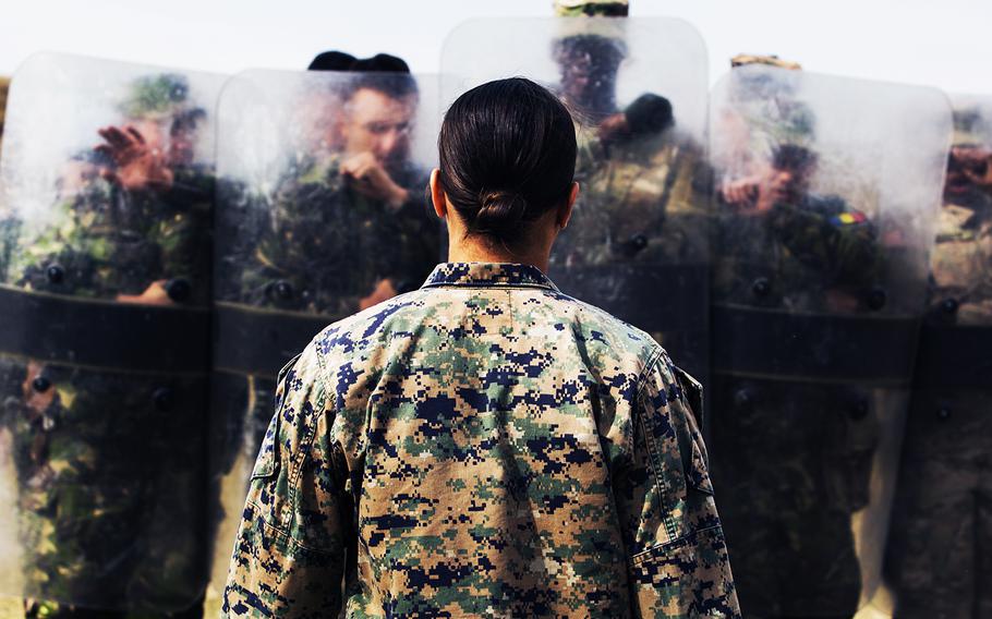 A female Marine demonstrates her capabilities in Marine Corps martial arts, non-lethal weapons, foreign weapons handling and combat lifesaving to Romanian and U.S. soldiers in Romania on Sept. 29, 2016.   