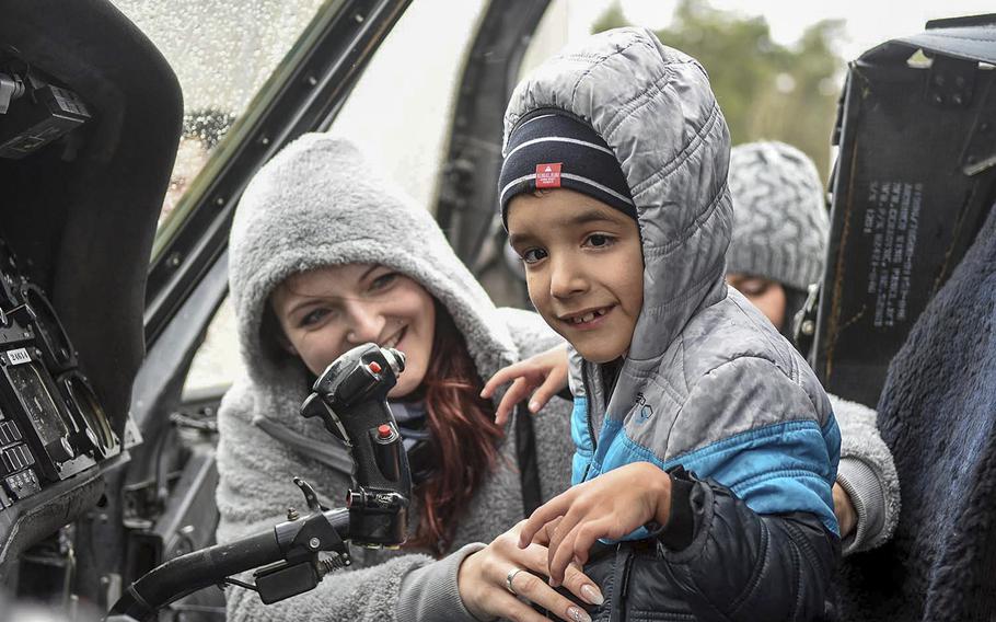 Damien Nelson and his mother Sonja inside a UH-60 helicopter, March 18, 2017, as they visited a display that allowed Damien and his brother Malik explore military vehicles.