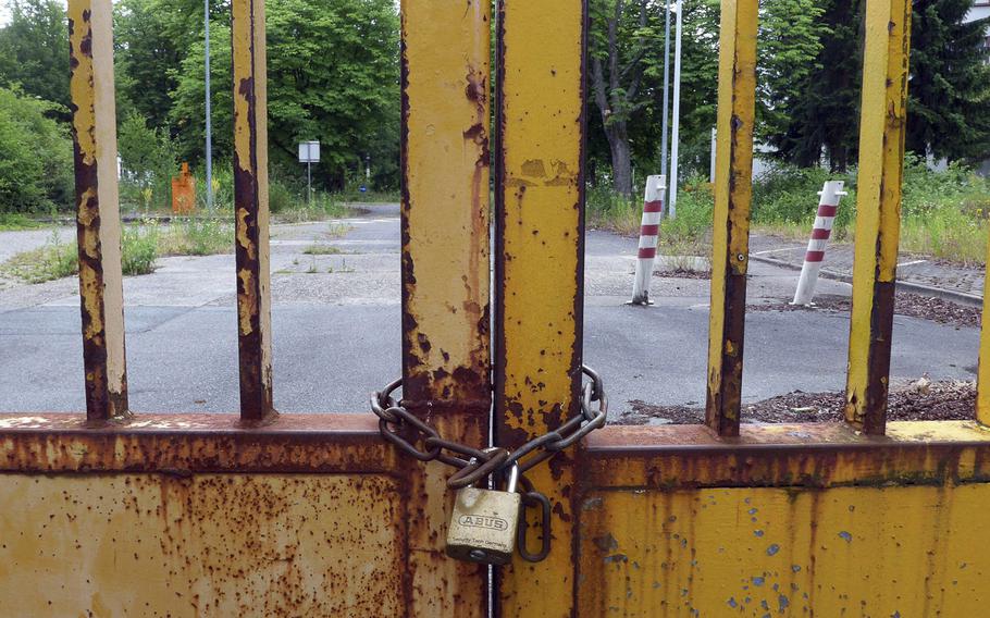 A locked gate bars entry to a former U.S. base in Darmstadt, Germany.
