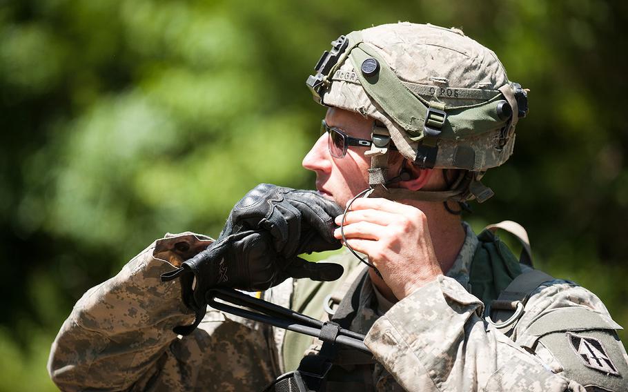 An infantryman with A Company, 1st Battalion, 151st Infantry Regiment, 76th Infantry Brigade, Indiana Army National Guard puts on his Advanced Combat Helmet in preparation for a patrol for mock enemy troops during a training exercise at Camp Atterbury, Indiana, Aug. 8, 2016.
