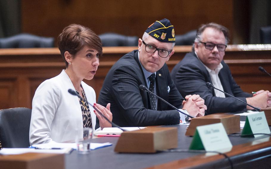 Retired Marine Corps Lt. Col. Kate Germano, left, her husband retired Marine Corps Lt. Col. Joe Plenzler, center and former Marine Capt. Greg Jacob take part in a panel discussion inside the Senate's Dirksen Building on Capitol Hill on Wednesday, April 5, 2017, as speakers addressed the status of integrating women into ground combat jobs.