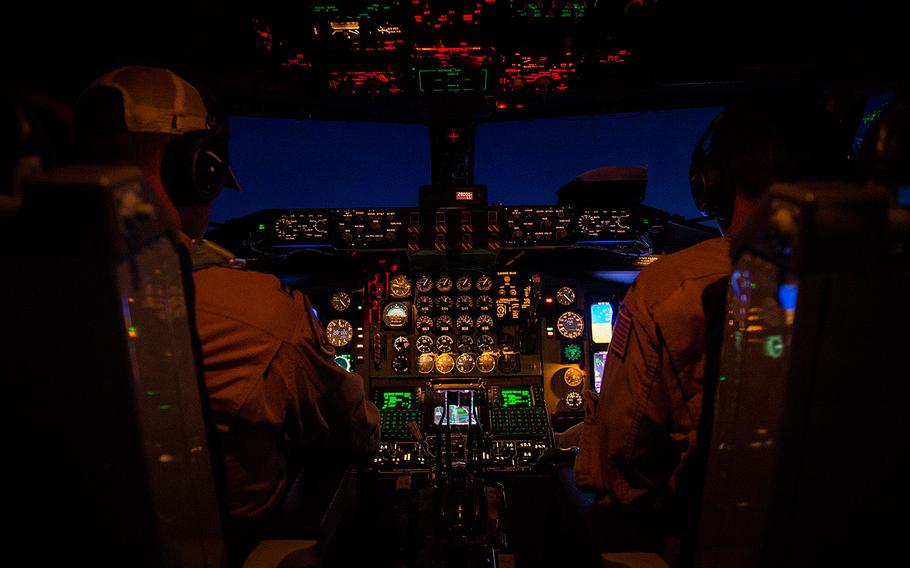 Two U.S. Air Force KC-135 Stratotanker pilots, assigned to the 340th Expeditionary Air Refueling Squadron, perform in-flight checklists during a flight in support of Operation Inherent Resolve April 27, 2017.
