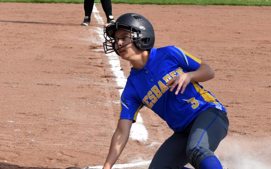 Kate Dimond with the Wiesbaden softball team looks up to see the call as she slides onto home plate during a game against Naples during the first day of the Softball Championship at Kaiserslautern, Germany, Thursday, May 25. 