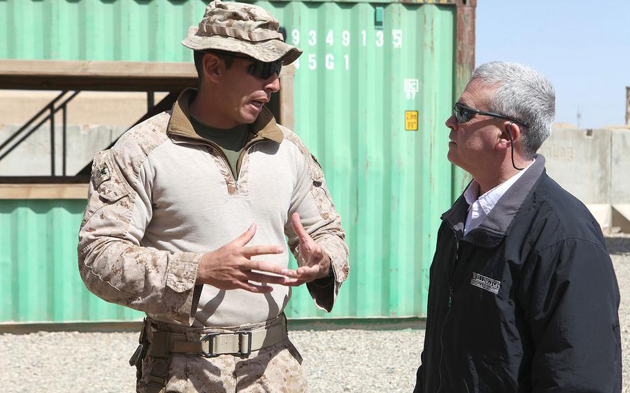 U.S. Rep. Brad Wenstrup, R-Ohio, speaks to a Navy corpsman about training at Camp Shorabak, Helmand province, Afghanistan on March 18, 2014. Wenstrup, along with four other members of congress, visited the base to get a firsthand look at the training procedures of the Afghan National Army.