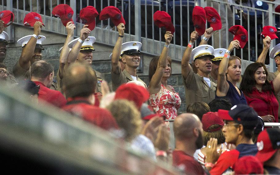 U.S. Marines in the stands acknowledge the cheers of the crowd between innings of a game between the Washington Nationals and Milwaukee Brewers at Nationals Park in Washington, D.C., July 25, 2017.
