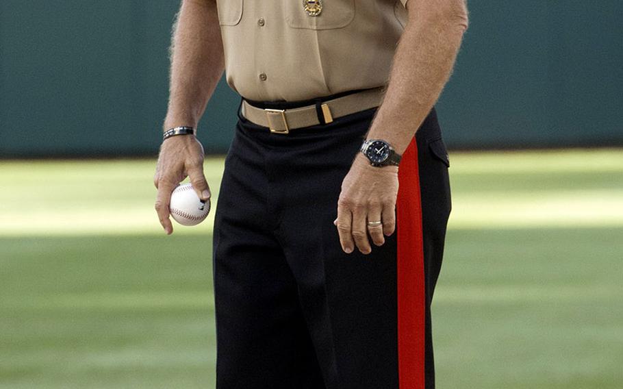 U.S. Marine Corps Commandant Gen. Robert Neller stands on the mound before the ceremonial first pitch at a game between the Washington Nationals and Milwaukee Brewers at Nationals Park in Washington, D.C., July 25, 2017.