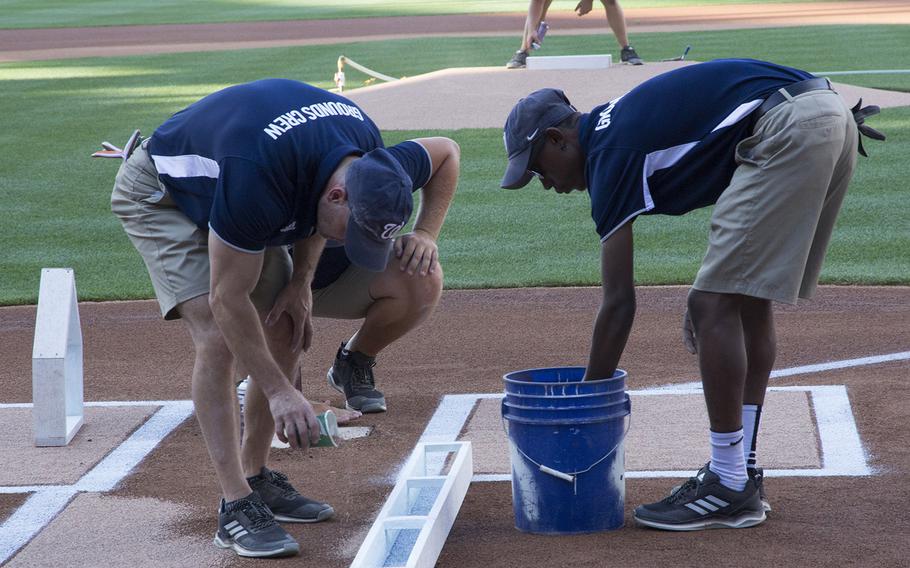 The grounds crew prepares the field before a game between the Washington Nationals and Milwaukee Brewers at Nationals Park in Washington, D.C., July 25, 2017.
