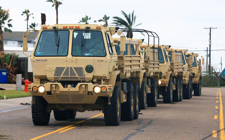 National Guard vehicles arrive at Port Aransas, Texas, after Hurricane Harvey landed in the Coast Bend area on Saturday, Aug. 26, 2017.