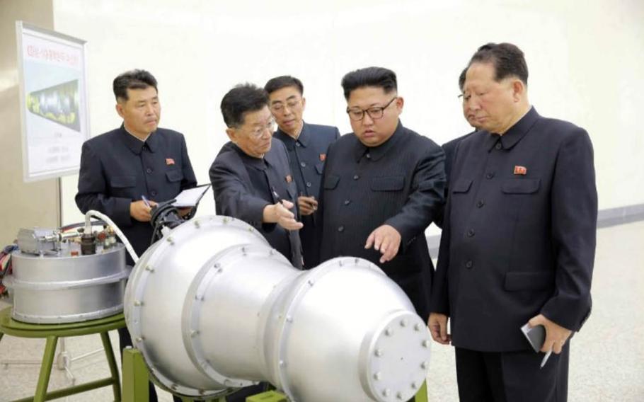 North Korean leader Kim Jong Un inspects the loading of a hydrogen bomb into a new intercontinental ballistic missile, Pyongyang's state media said Sunday, Sept. 3, 2017.  