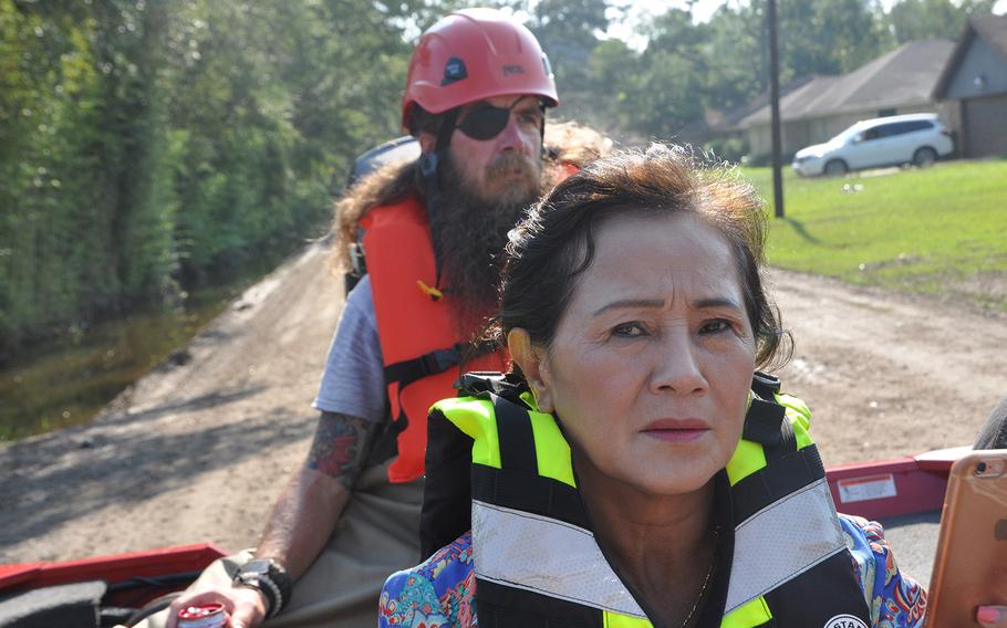 Van Ngo, sits in a boat about to enter flood waters in her Beaumont, Texas neighborhood on Sept. 2, 2017 to retrieve her parents’ medication from her flooded home. Behind her is Stephen Reid, a former police officer from New York City, and a member of the non-profit veterans organization Team Rubicon, that utilizes veterans skills to respond to disasters. 