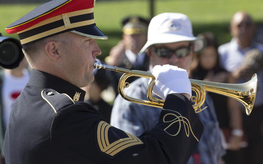 Bugler Master Sgt. Todd Taylor plays taps at a ceremony for "Remembering Our Fallen," a traveling tribute to those who have died since 9/11 in the war against terrorism, September 7, 2017 at the Lincoln Memorial in Washington, D.C.