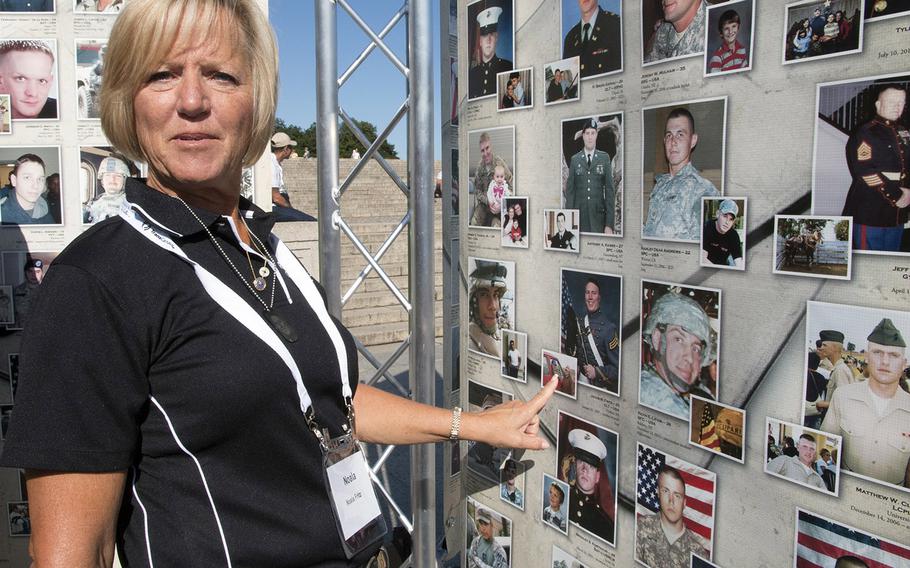 Gold Star Mother Noala Fritz, whose son, Army 1st Lt. Jacob N. Fritz, was killed in Iraq on Jan. 20, 2007, points to the photos of her son on a panel of "Remembering Our Fallen," a traveling tribute to those who have died since 9/11 in the war against terrorism, September 7, 2017 at the Lincoln Memorial in Washington, D.C.
Joe Gromelski/Stars and Stripes